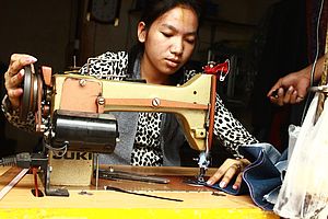 Eine Näherin in Kambodscha arbeitet mit einer Nähmaschine