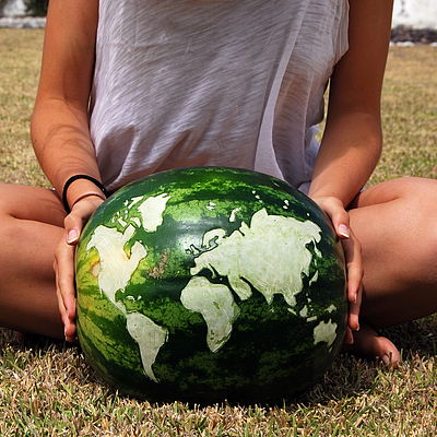 Siegerbild, Oberkörper mit Wassermelone, die wie Weltkarte aussieht
